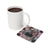 Mug of coffee next to square coaster with tattoo art and "Dull Your Sparkle" text.