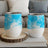 Two white wine tumblers with blue abstract watercolor design.