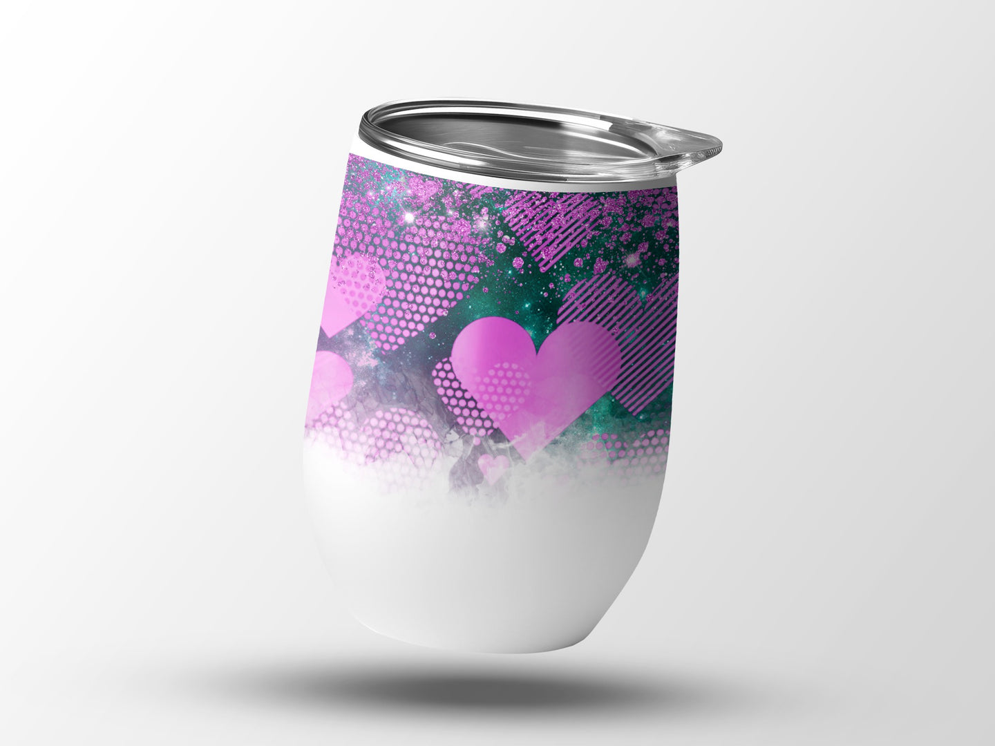 White tumbler with pink and teal heart and geometric pattern.