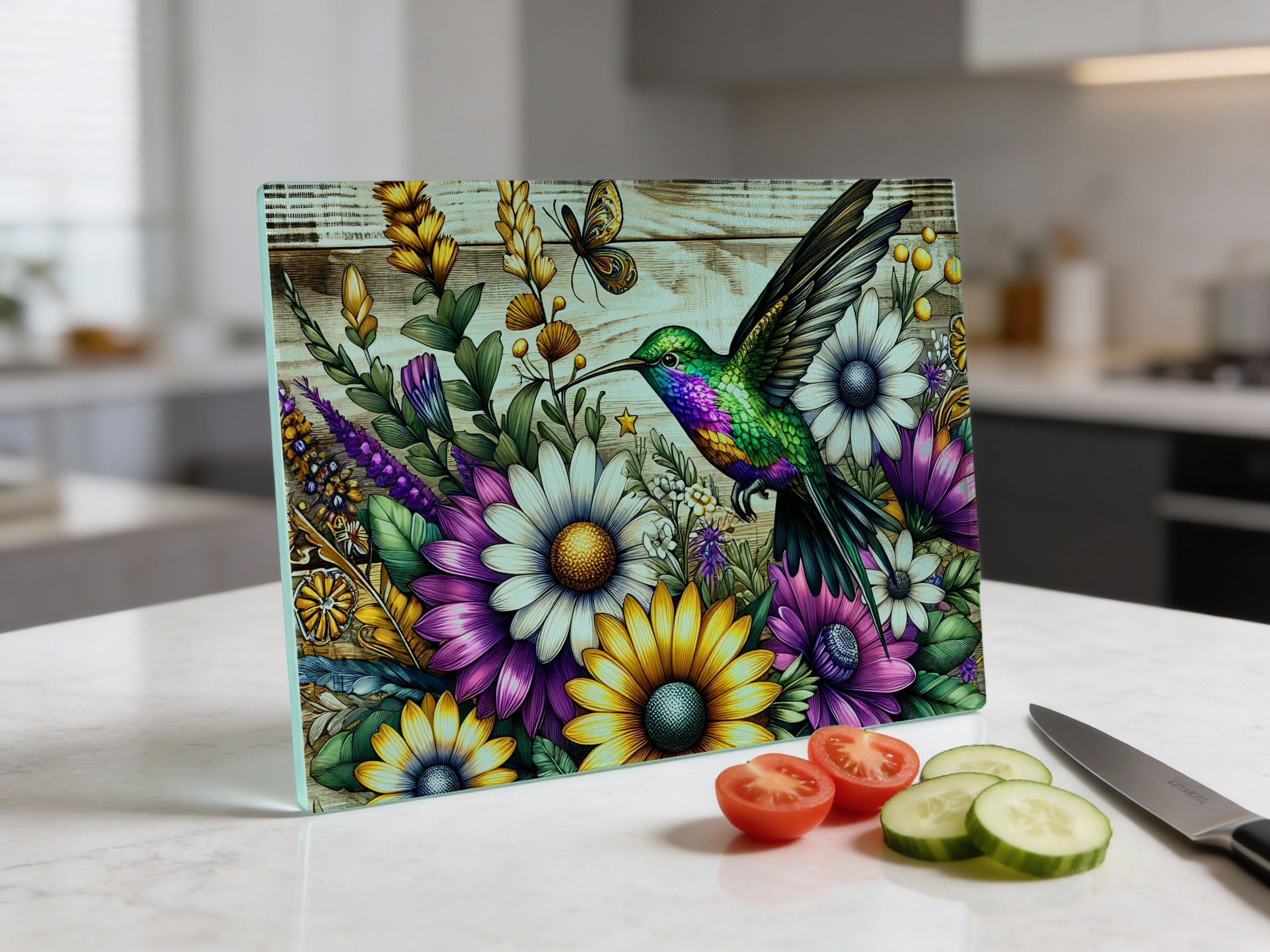 Hummingbird and flowers cutting board with tomatoes and cucumber slices.