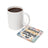 White mug of coffee next to a square coaster with "Beautiful things are coming into my life" text.