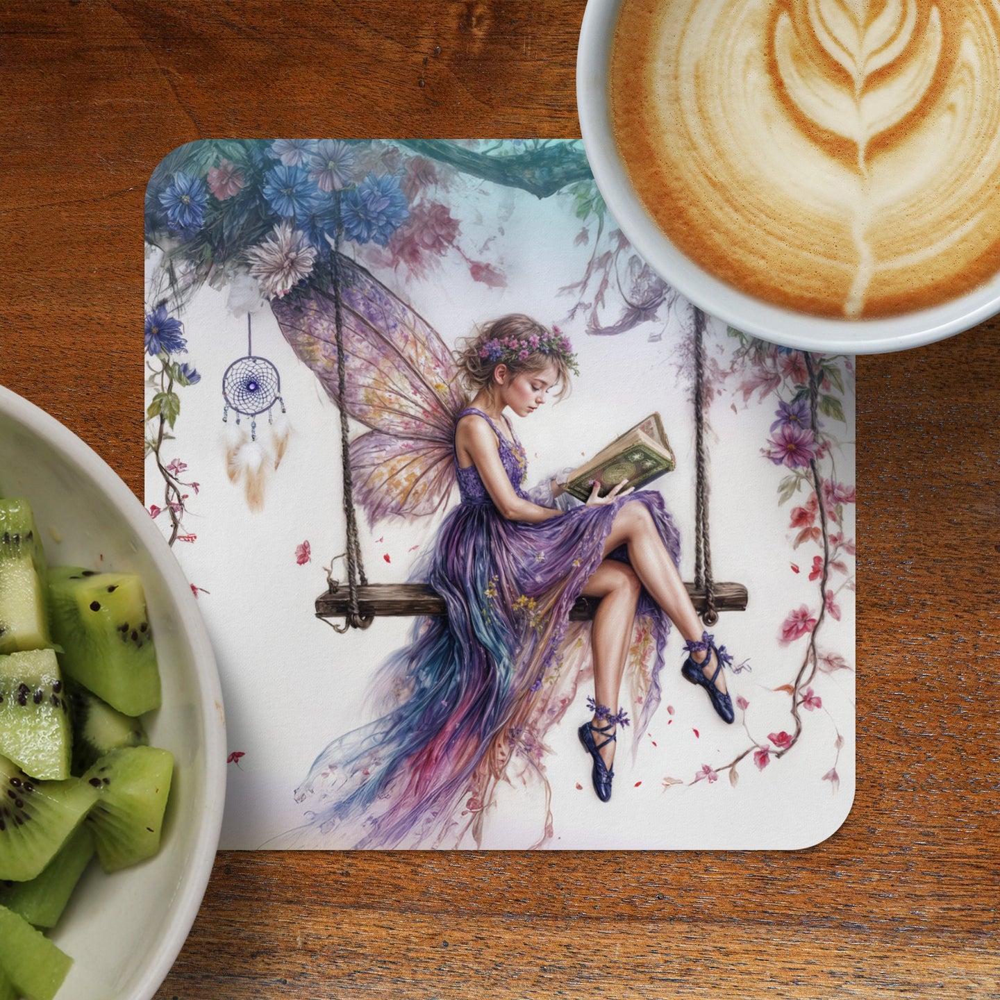 Fairy reading a book while sitting on a swing, with latte and kiwi slices.