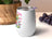 White stemless wine tumbler with colorful cocktail graphics and text "LESS ALCOHOL".