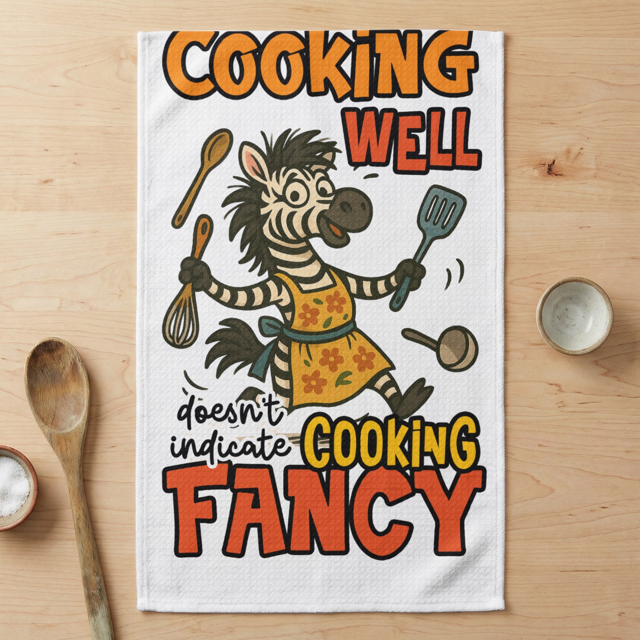 Zebra wearing apron, whisking and holding spatula, with text "COOKING WELL doesn't indicate COOKING FANCY".