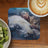Painting of a woman sleeping on a white buffalo, with kiwi and coffee.