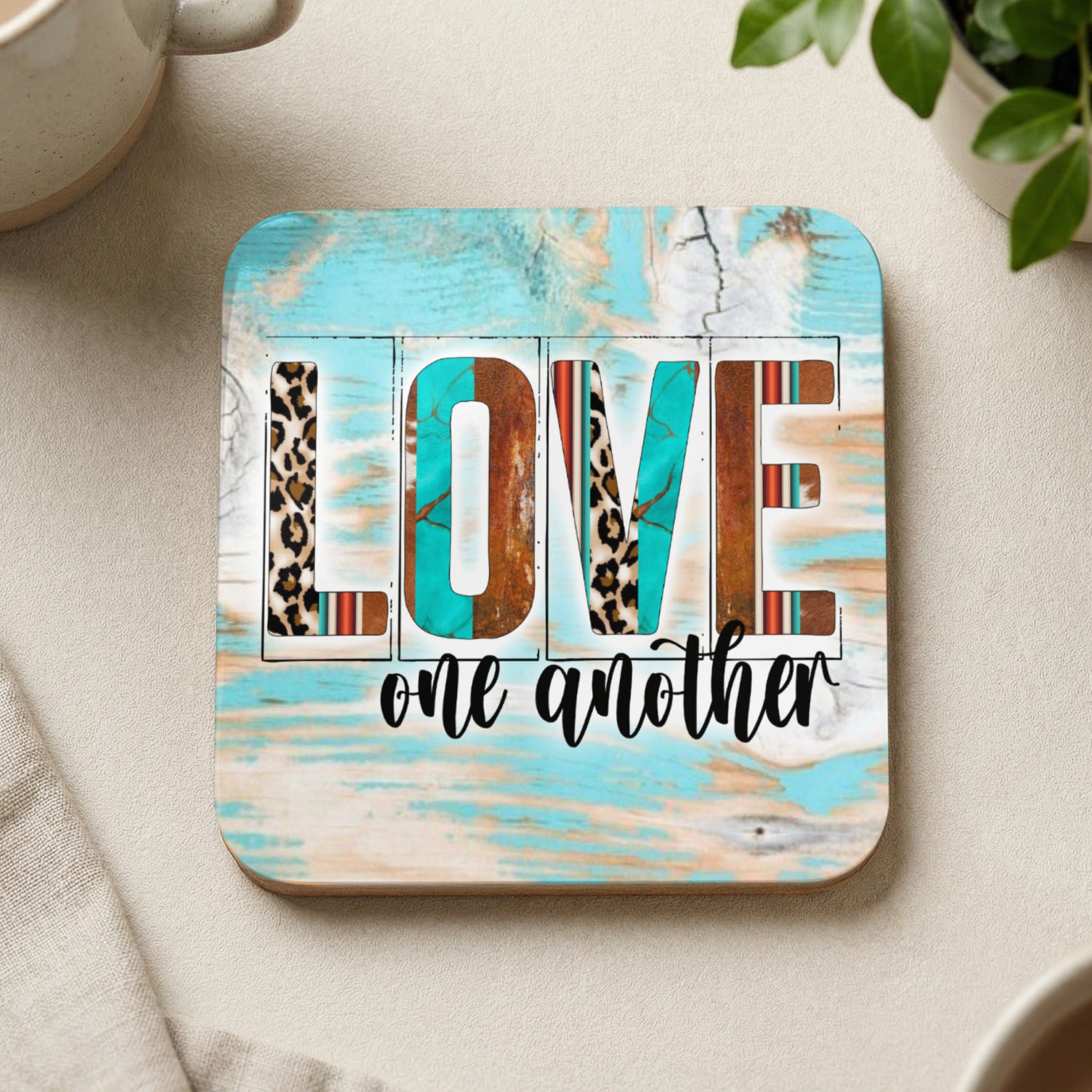 Square coaster with "LOVE one another" in patterned letters.