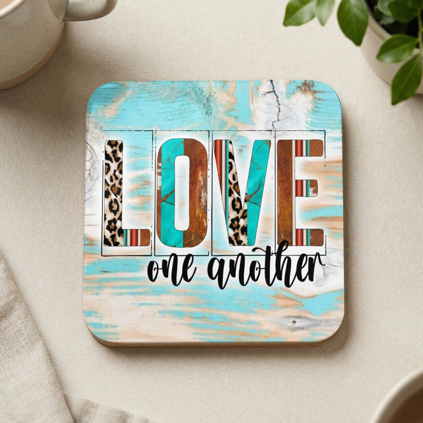 Square coaster with "LOVE one another" in patterned letters.