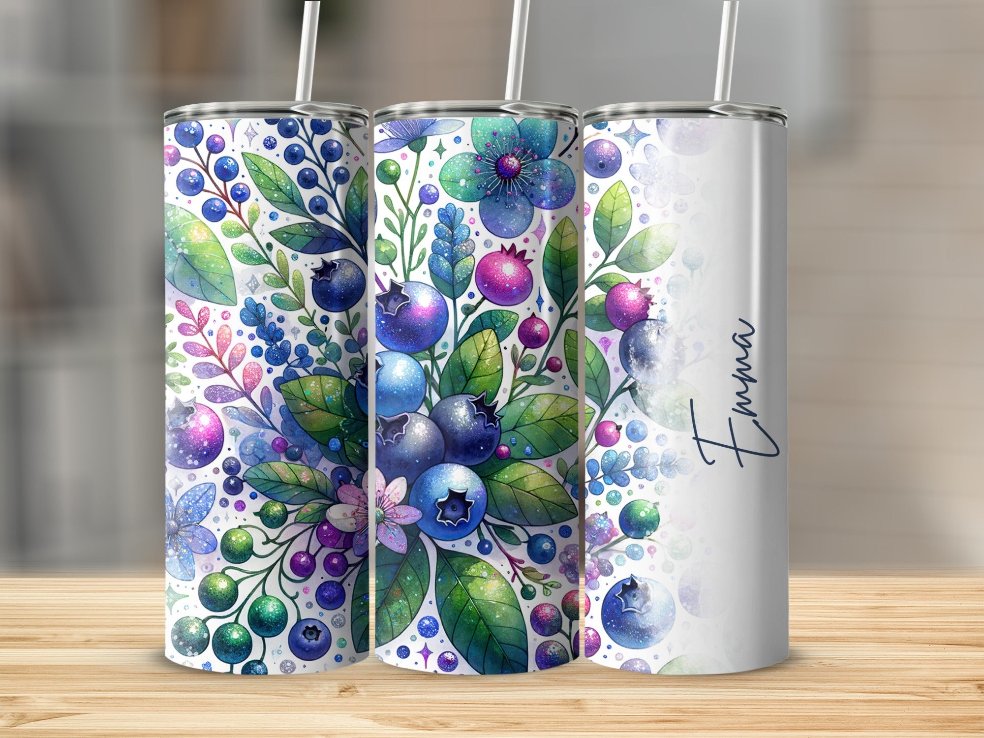 Two tumblers with blueberry floral designs and "Emma" on the right tumbler.