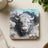 White buffalo head bursting through cracked surface.