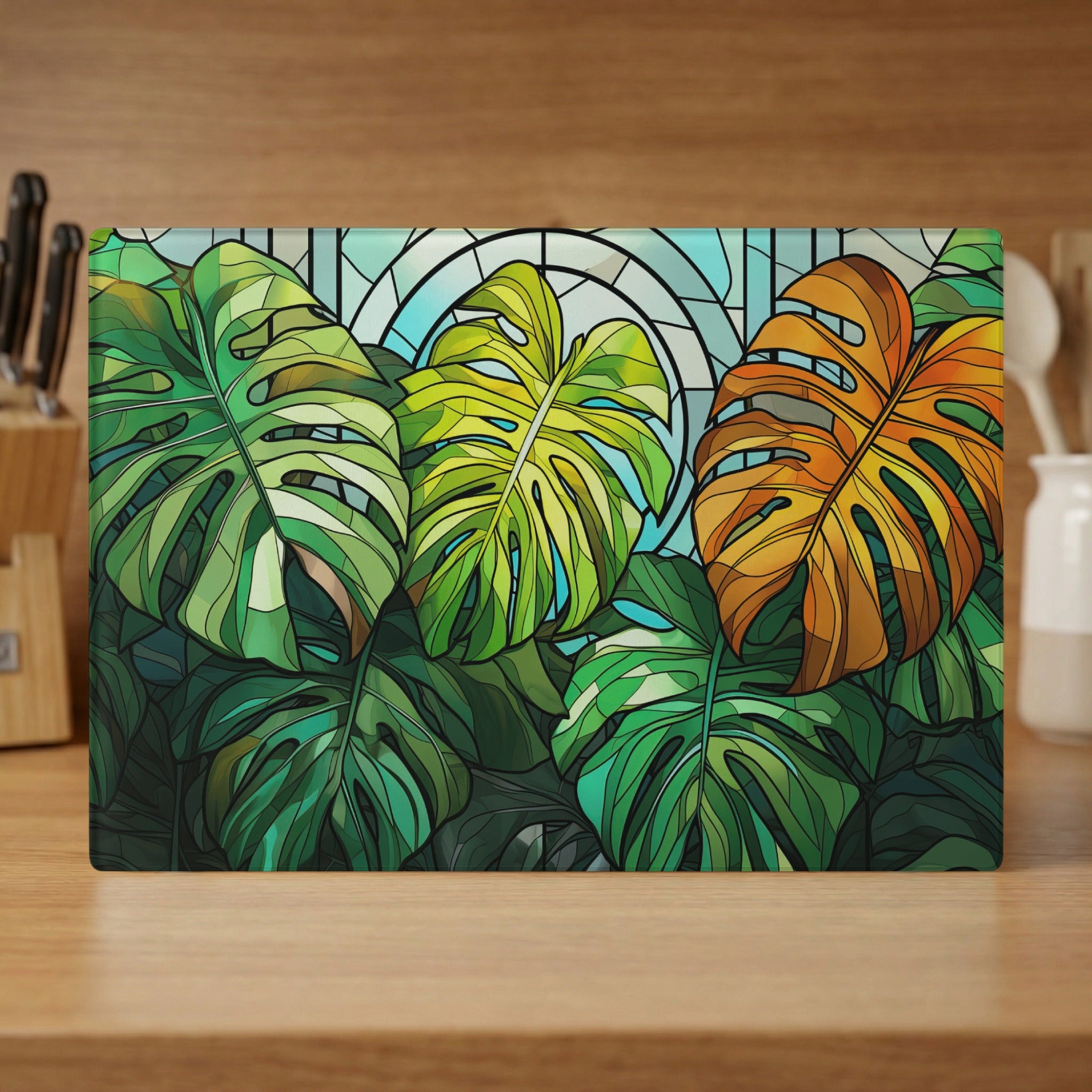 Monstera leaves in shades of green, yellow, and orange against stained glass.