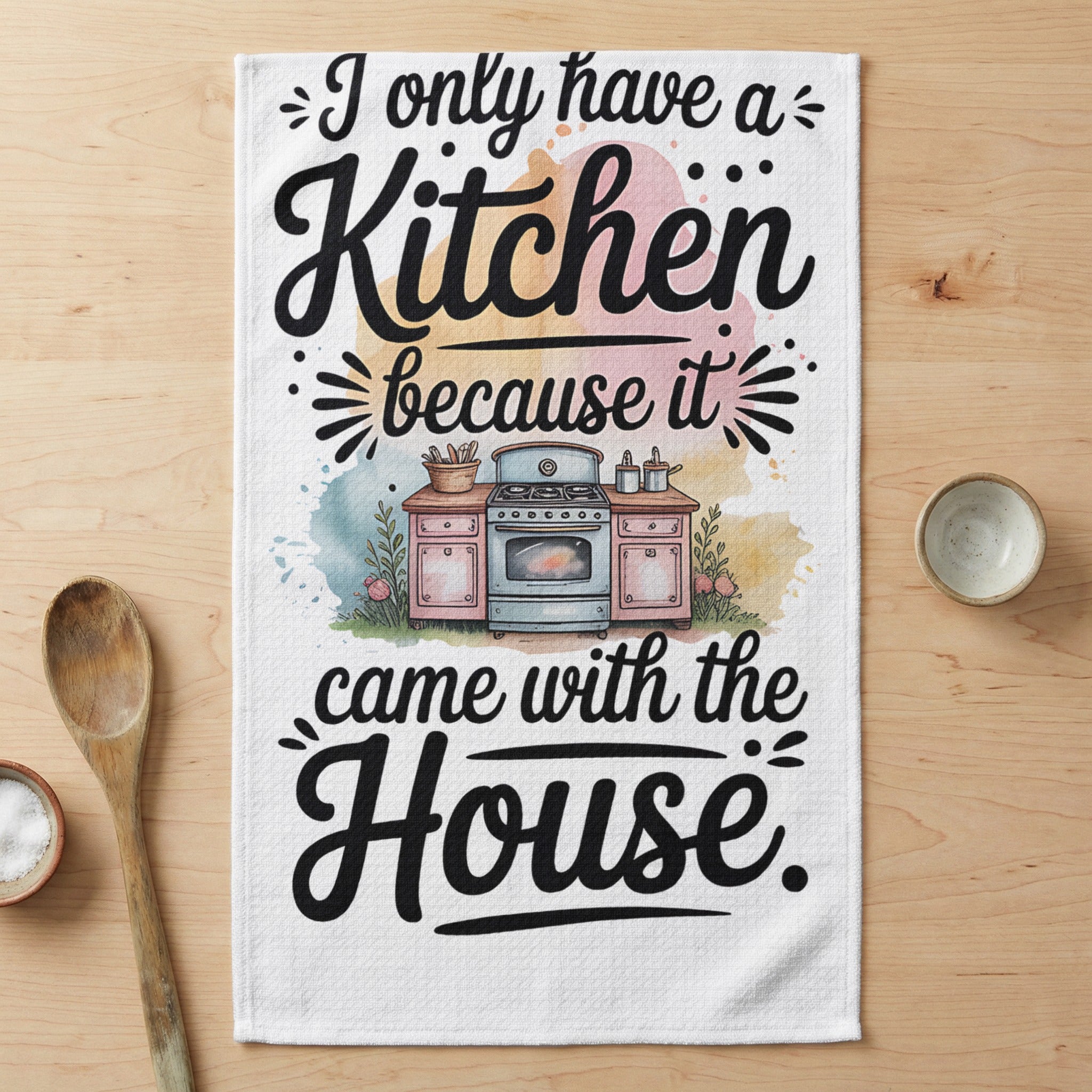 Towel with illustration of a kitchen stove and quote, "I only have a Kitchen because it came with the House."