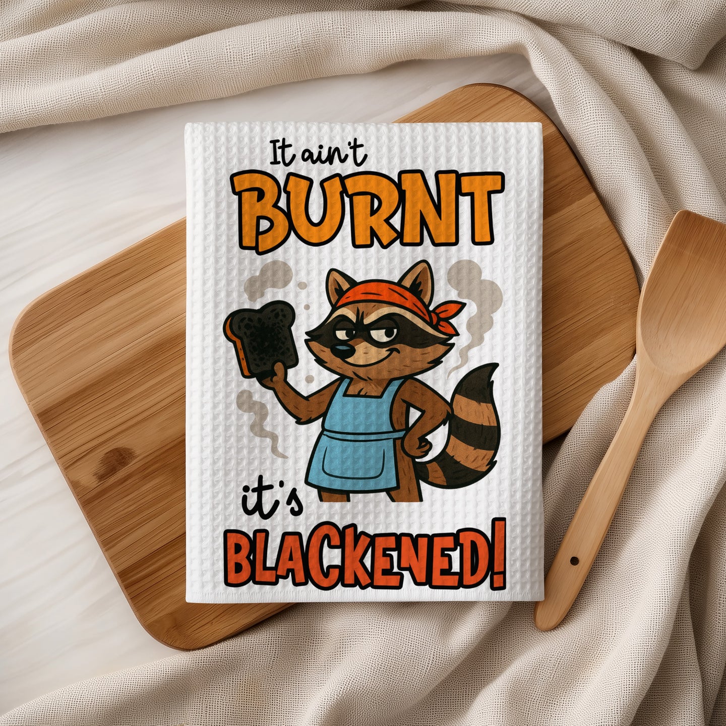Burnt and blackened raccoon chef with bread on wooden cutting board.