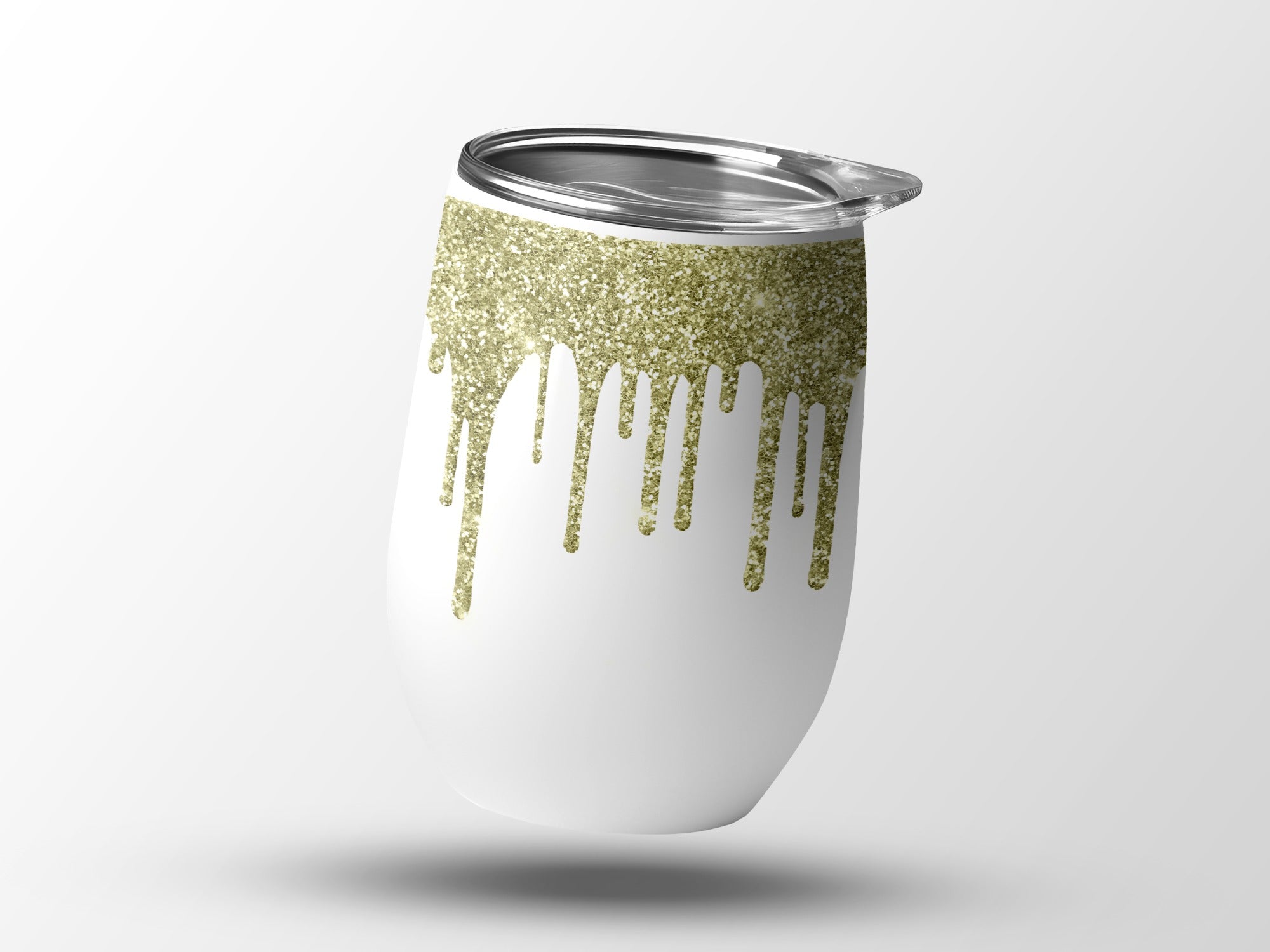 White tumbler with gold glitter drips and silver lid.