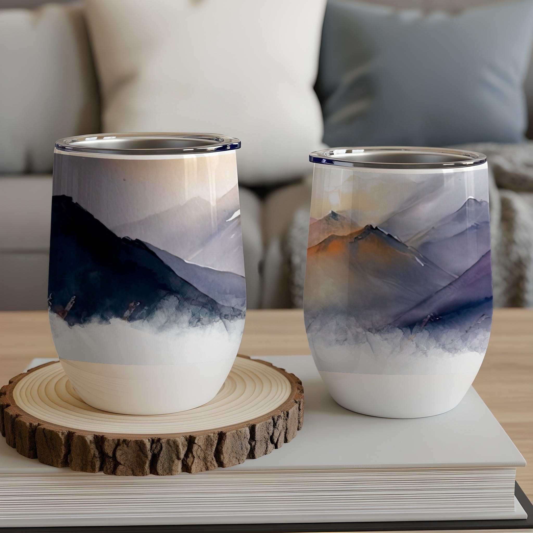 Two insulated tumblers with abstract mountain watercolor designs.
