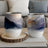 Two insulated tumblers with abstract mountain watercolor designs.