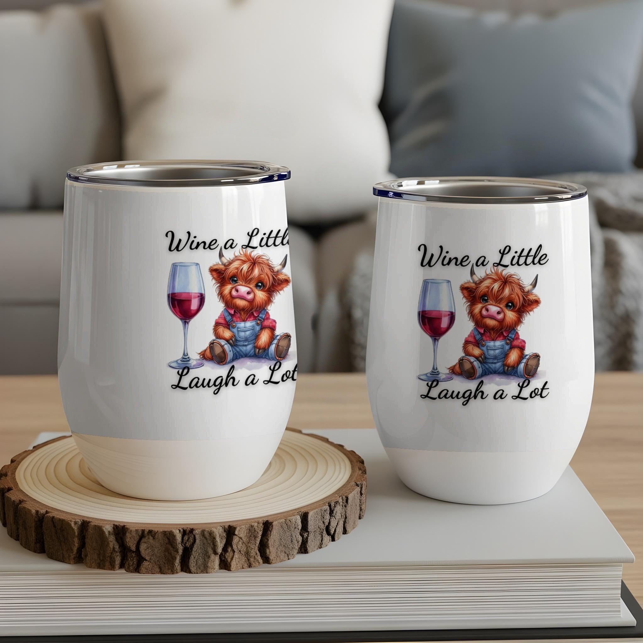 Two wine tumblers featuring a cartoon highland cow and text "Wine a Little, Laugh a Lot".