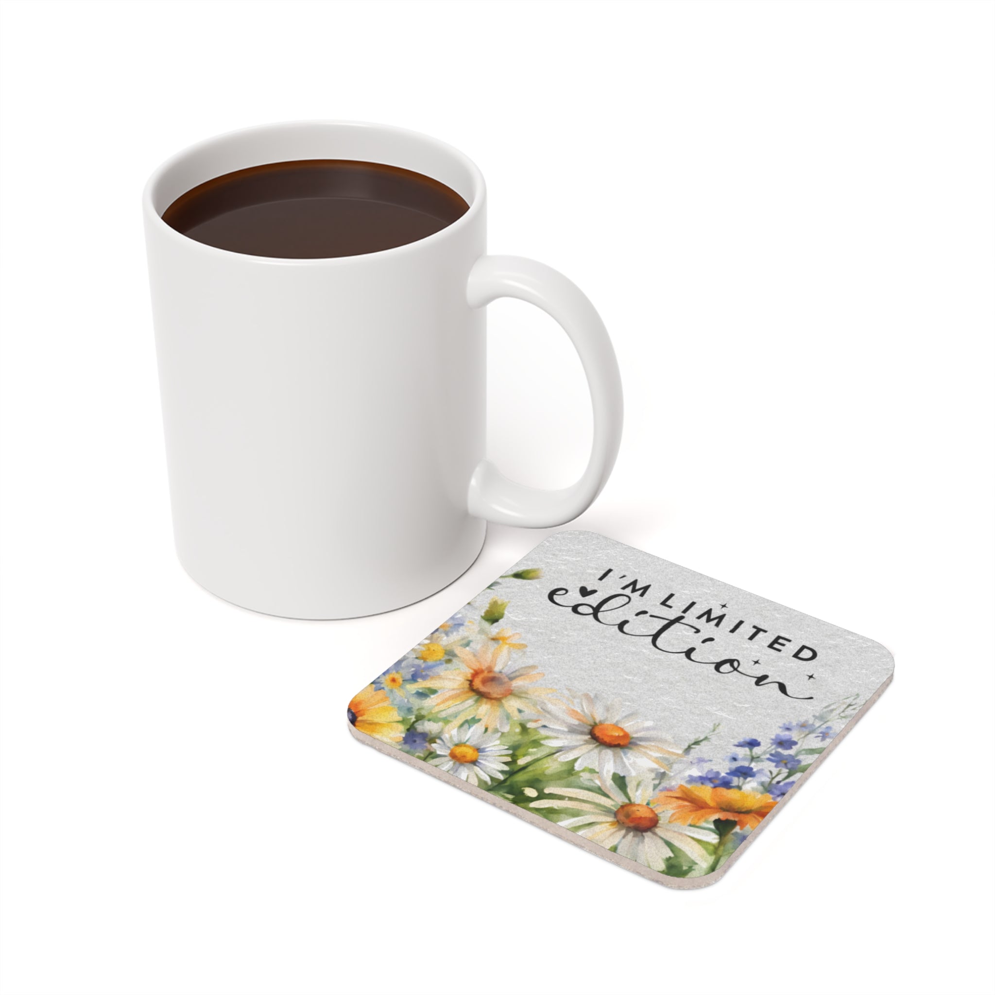 White mug next to a floral coaster reading "I'm limited edition."