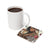 White mug of coffee next to a coaster with a tattooed woman and "ENTREPRENEUR" text.