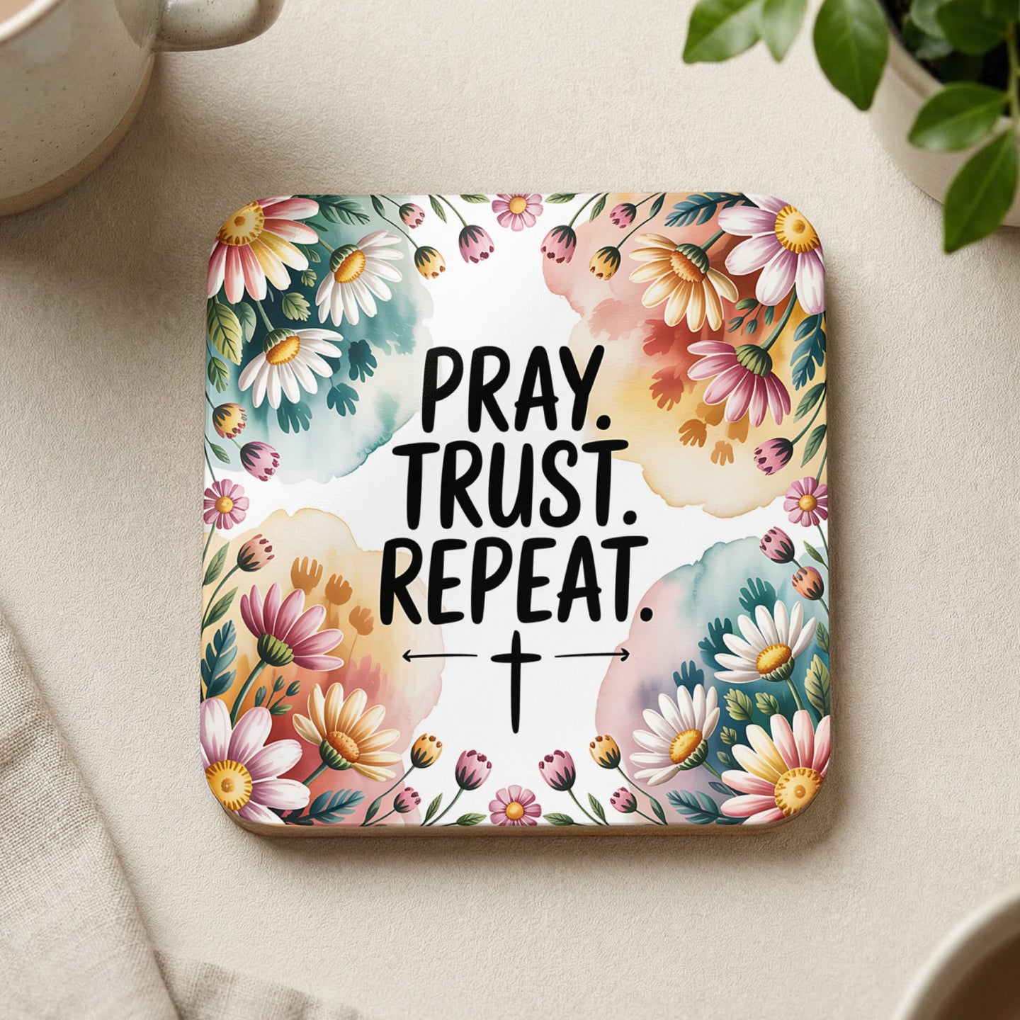 Square coaster with colorful floral border and "Pray. Trust. Repeat." text.