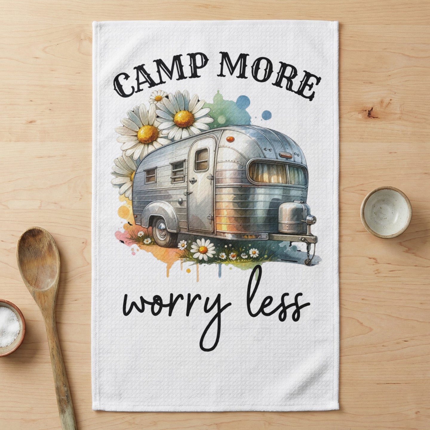 Vintage camper with daisies and text "CAMP MORE WORRY LESS".