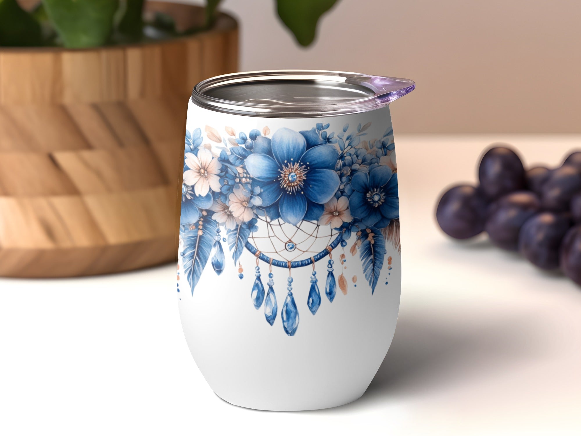 White tumbler with blue floral and dreamcatcher design.