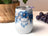 White tumbler with blue floral and dreamcatcher design.