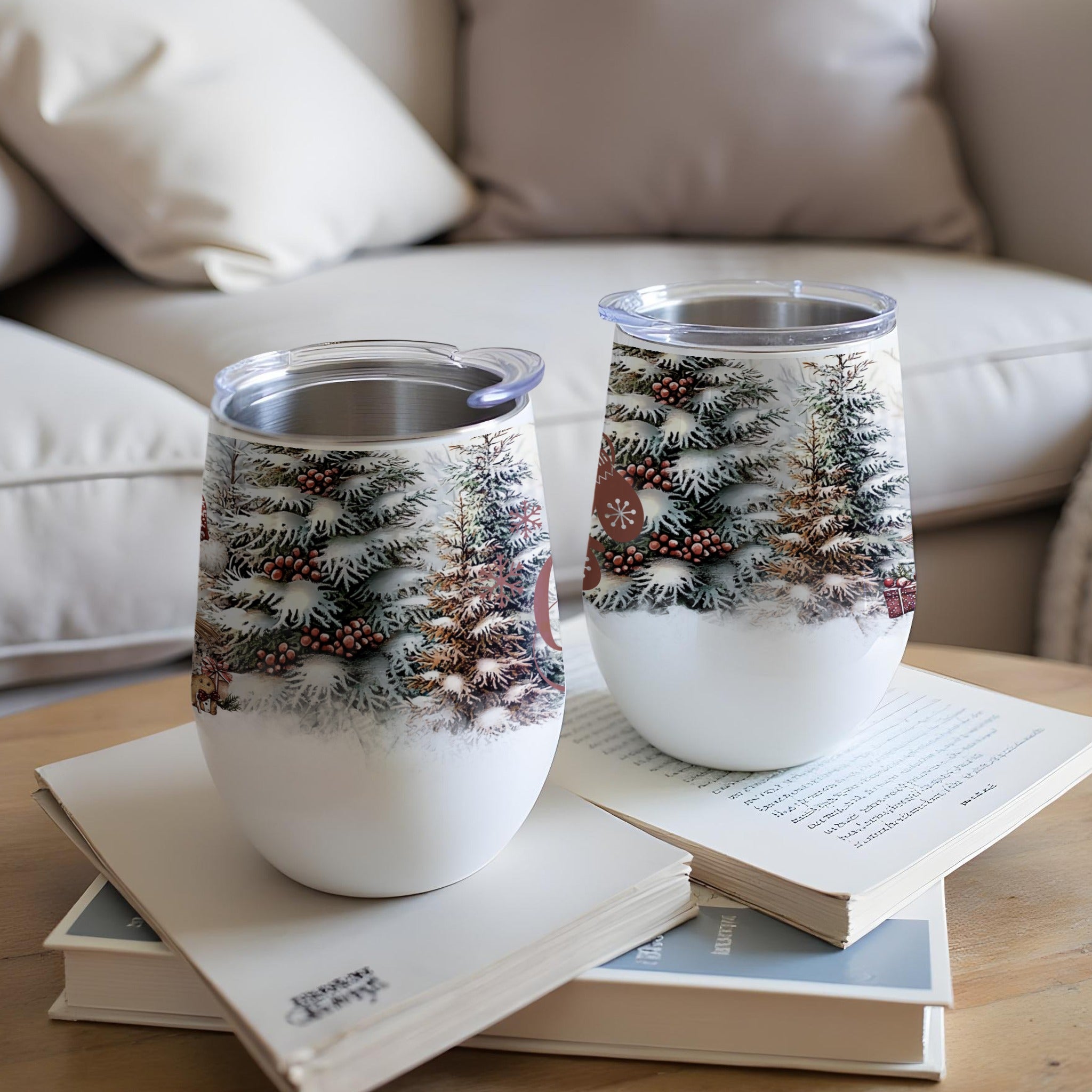 Two insulated wine tumblers with a snowy forest and cabin design.
