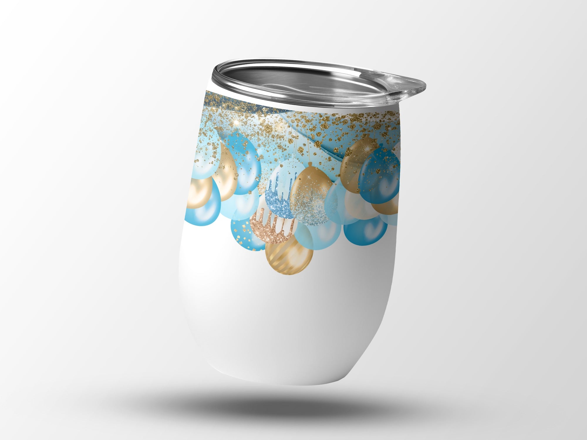 White tumbler with gold and blue glitter balloon design and silver lid.