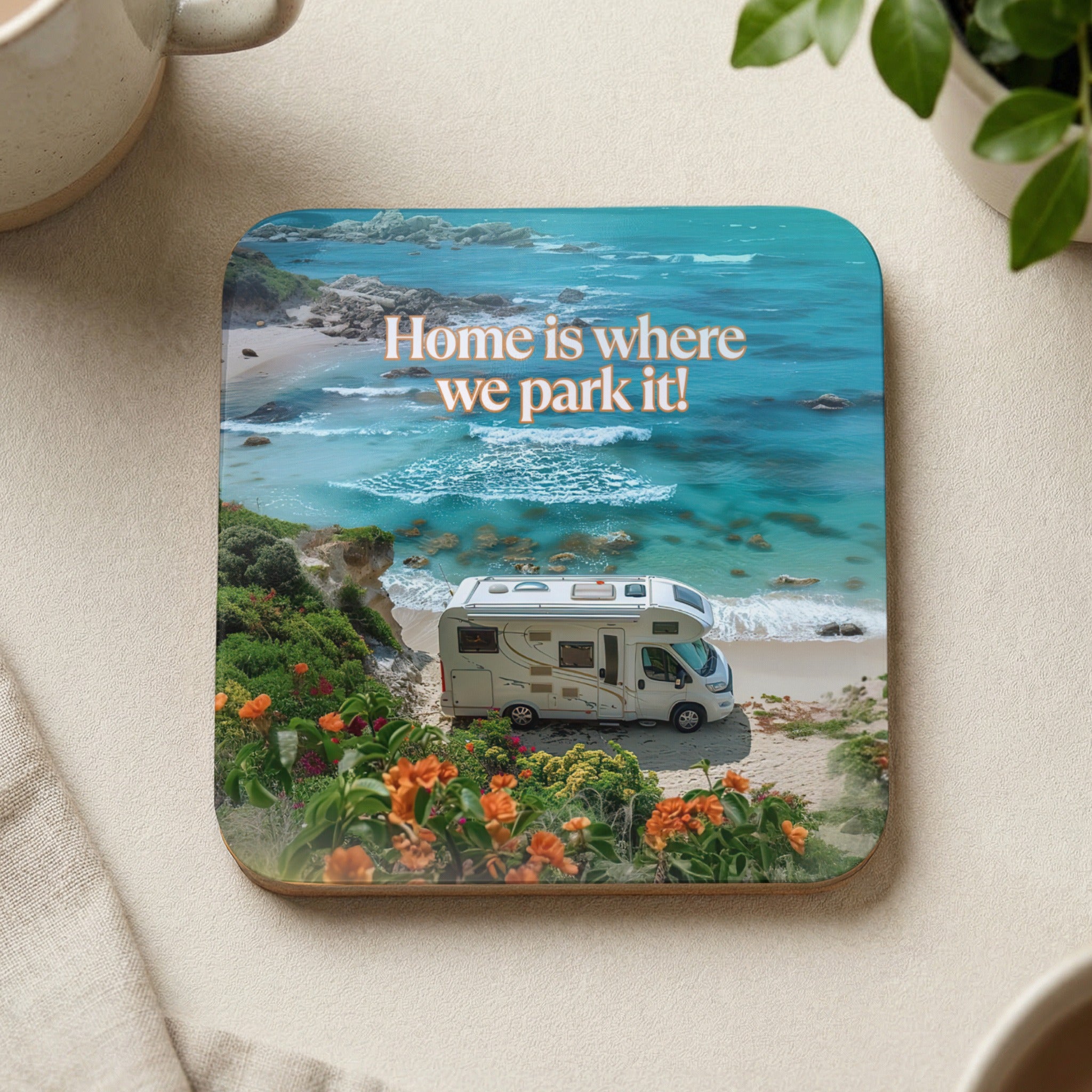RV parked on a beach with text "Home is where we park it!".