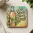 Coaster with a beer bottle and tropical leaves, reading "Eat, Sleep, Beer, Repeat".