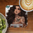 Woman with tattoos and "Entrepreneur Mode On Off" text on a coaster near kiwi and coffee.