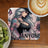 Tattooed woman with "Never anyone" text on a coaster, beside kiwi and coffee.
