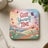 Coaster with "Give Yourself Time" text and colorful landscape with butterflies.