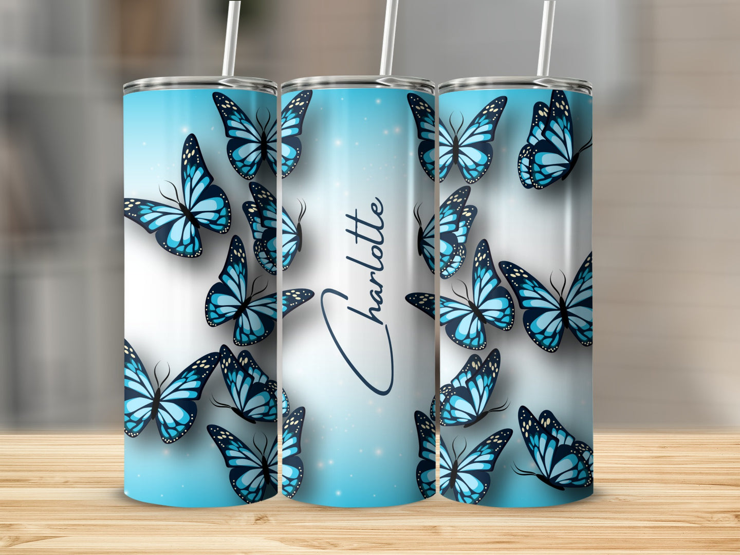 Blue butterflies with "Charlotte" text on a gradient tumbler.