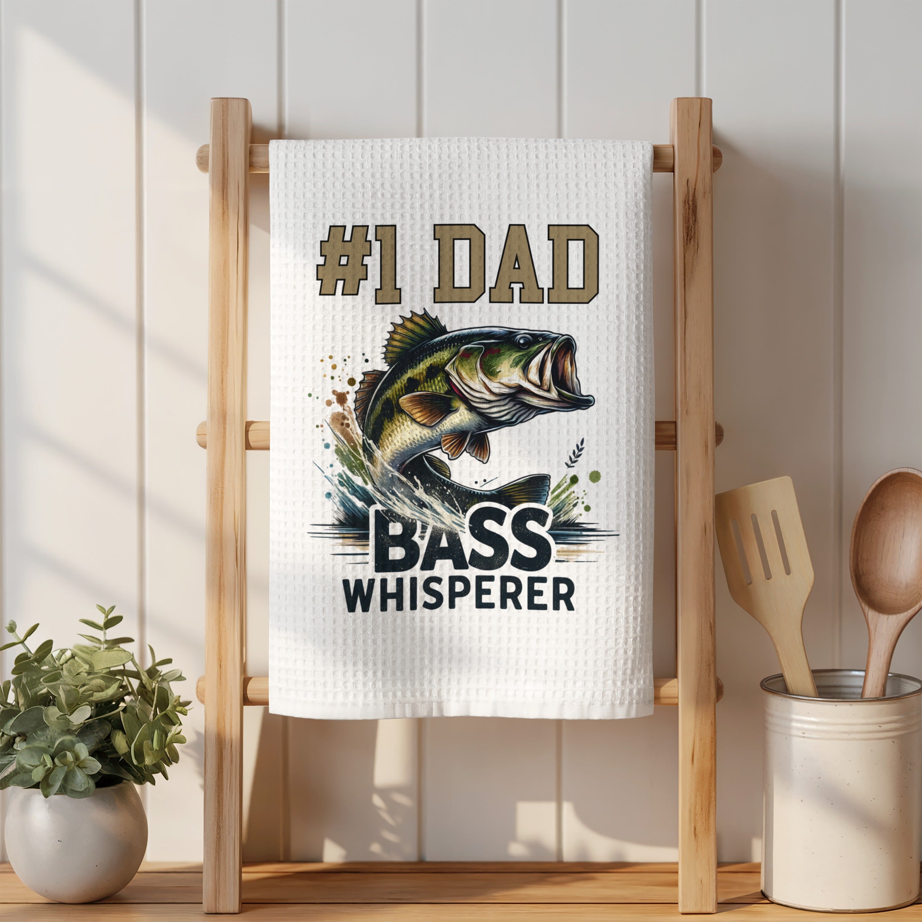 Towel with "#1 Dad Bass Whisperer" text and a jumping bass fish graphic.
