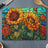 Sunflowers and orange flowers bloom on a stained-glass cutting board.