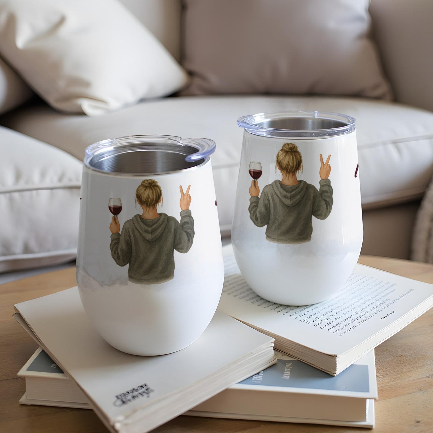 Two white stemless wine tumblers with a woman making a peace sign holding wine.