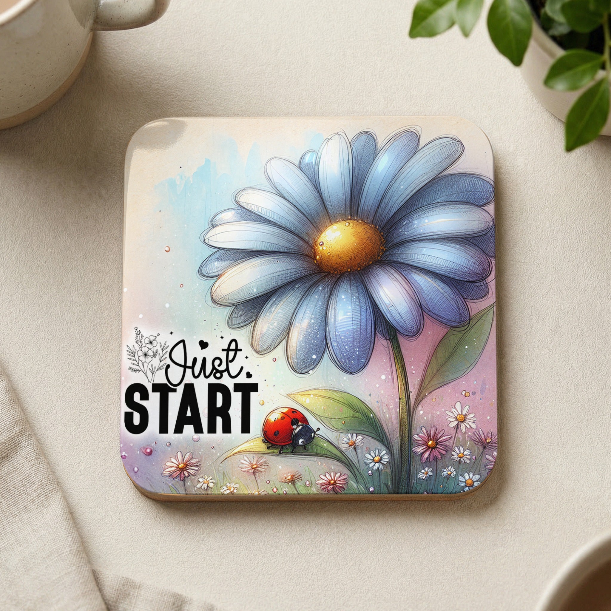 Blue daisy with ladybug and text "Just Start" on a coaster.