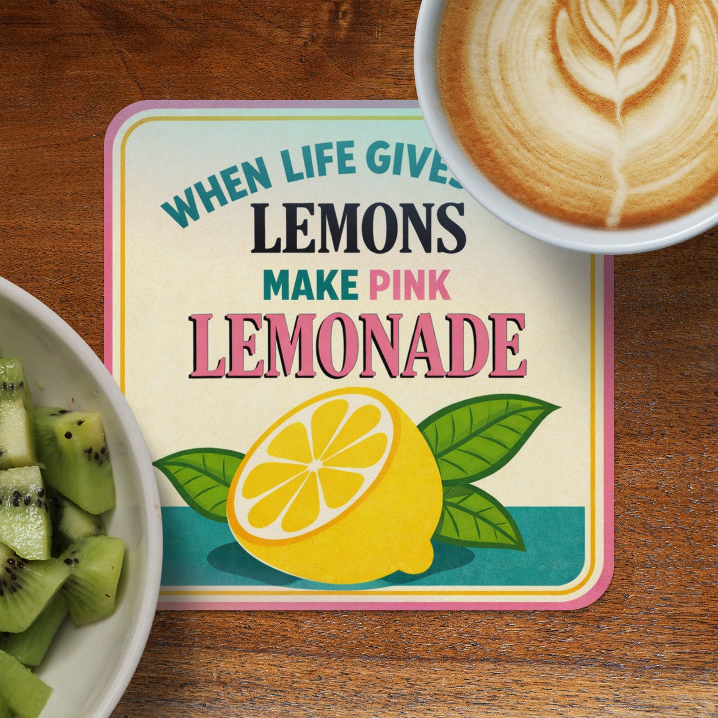 Coaster with lemons, leaves, and text "When life gives lemons make pink lemonade".