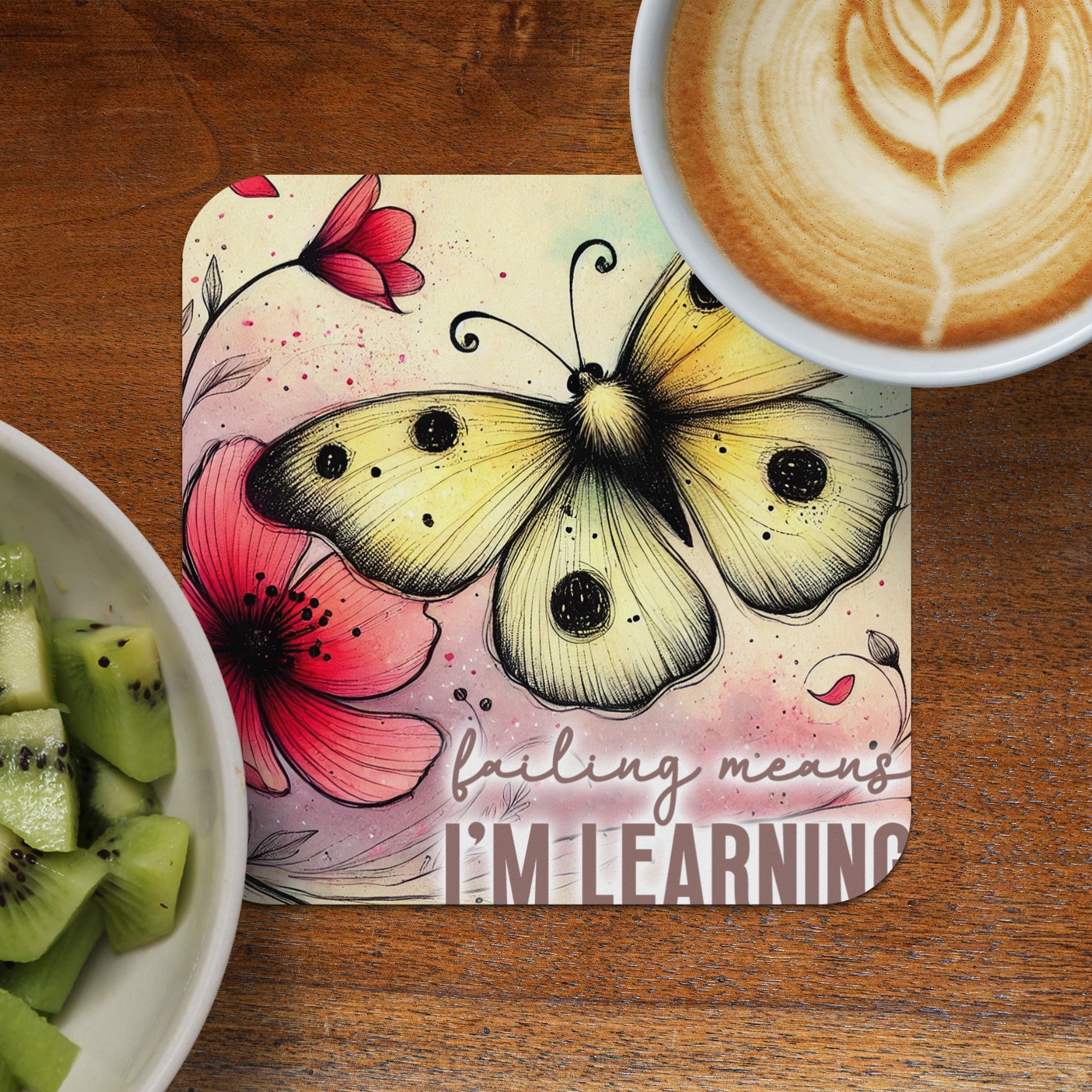 Yellow butterfly and flowers on a square coaster with inspirational text.