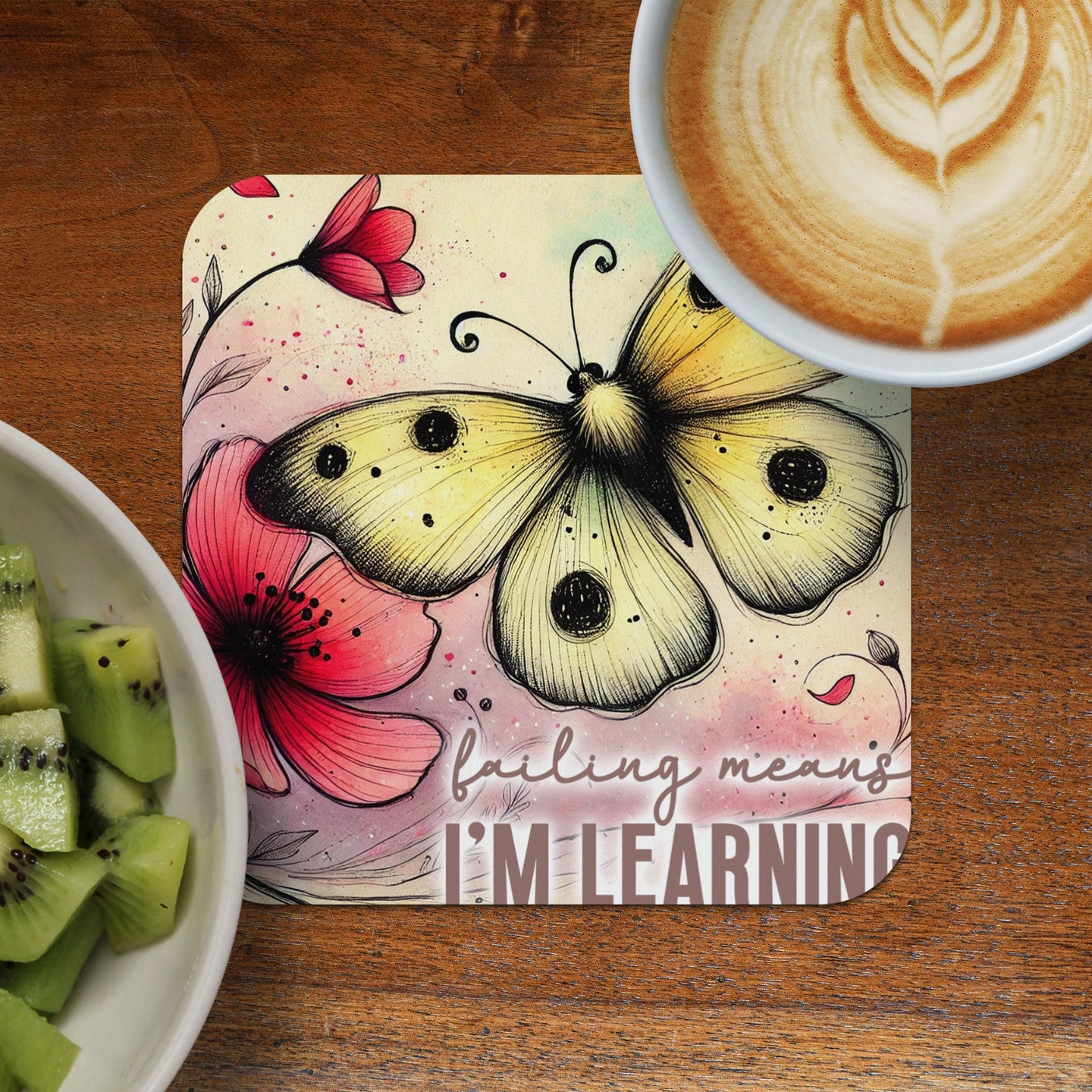 Yellow butterfly and flowers on a square coaster with inspirational text.