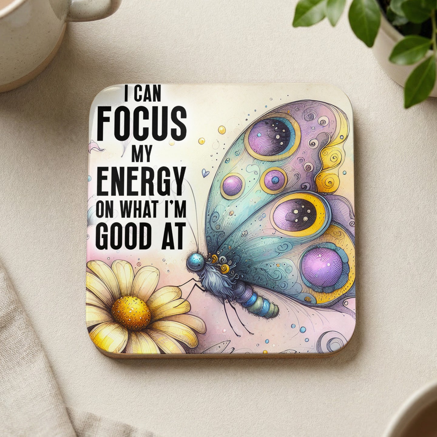 Coaster with inspirational quote and colorful butterfly on a daisy.
