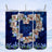 Collage of family birthday photos on a blue marble textured tumbler with floral accents.