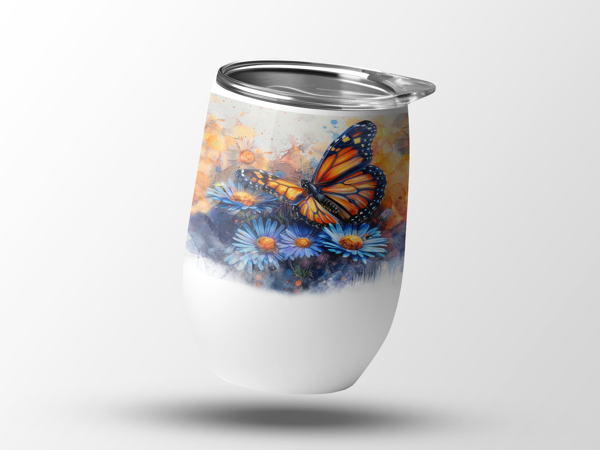 White insulated tumbler with monarch butterfly and blue flowers art.