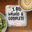Coaster with "I am whole & complete" text, kiwi slices, and coffee.