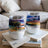 Two tumblers with colorful abstract landscape art on a coffee table.