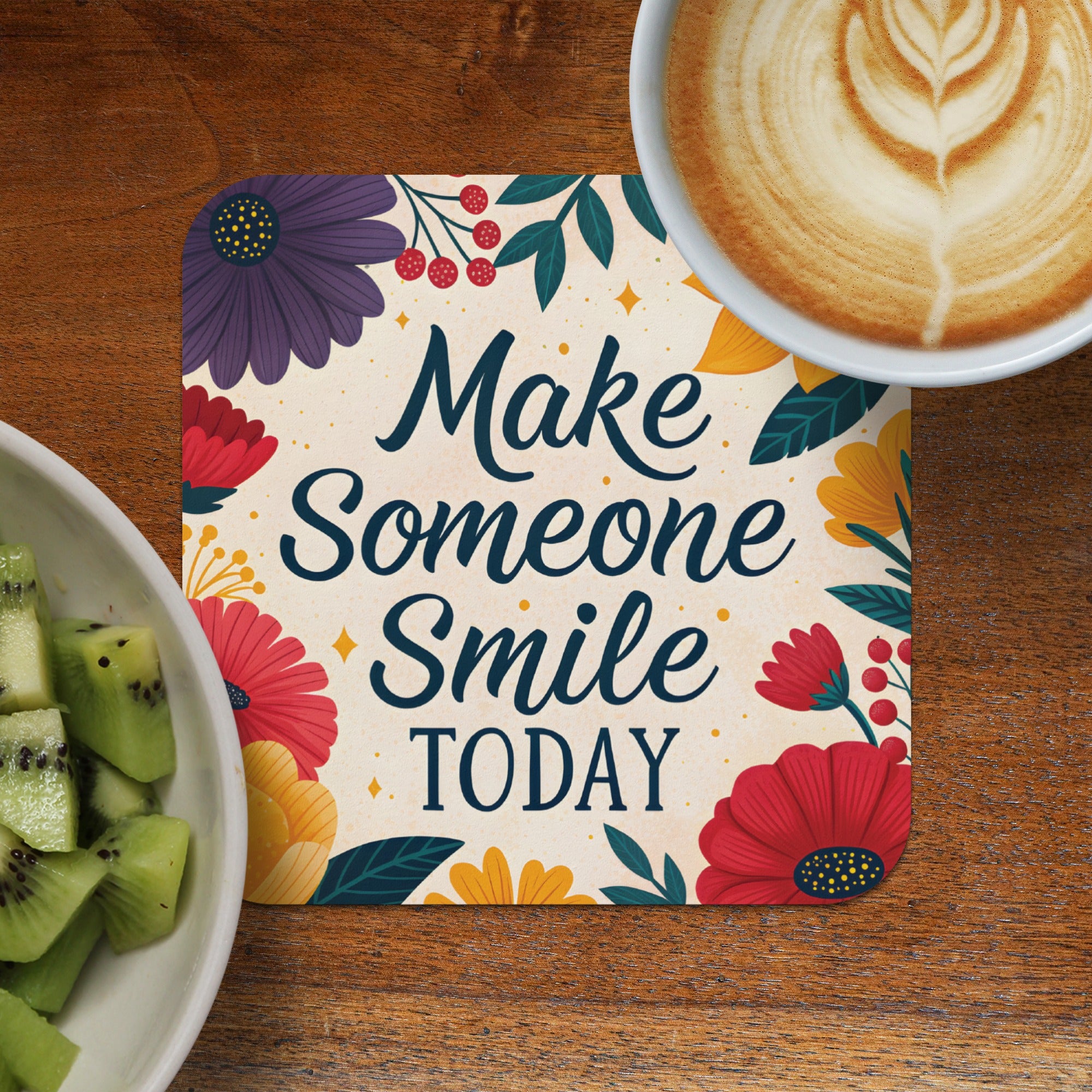 Coaster with floral design and "Make Someone Smile TODAY" text next to kiwi and coffee.
