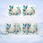 Blue butterflies and flowers adorn a mug with "Happy Birthday" text.