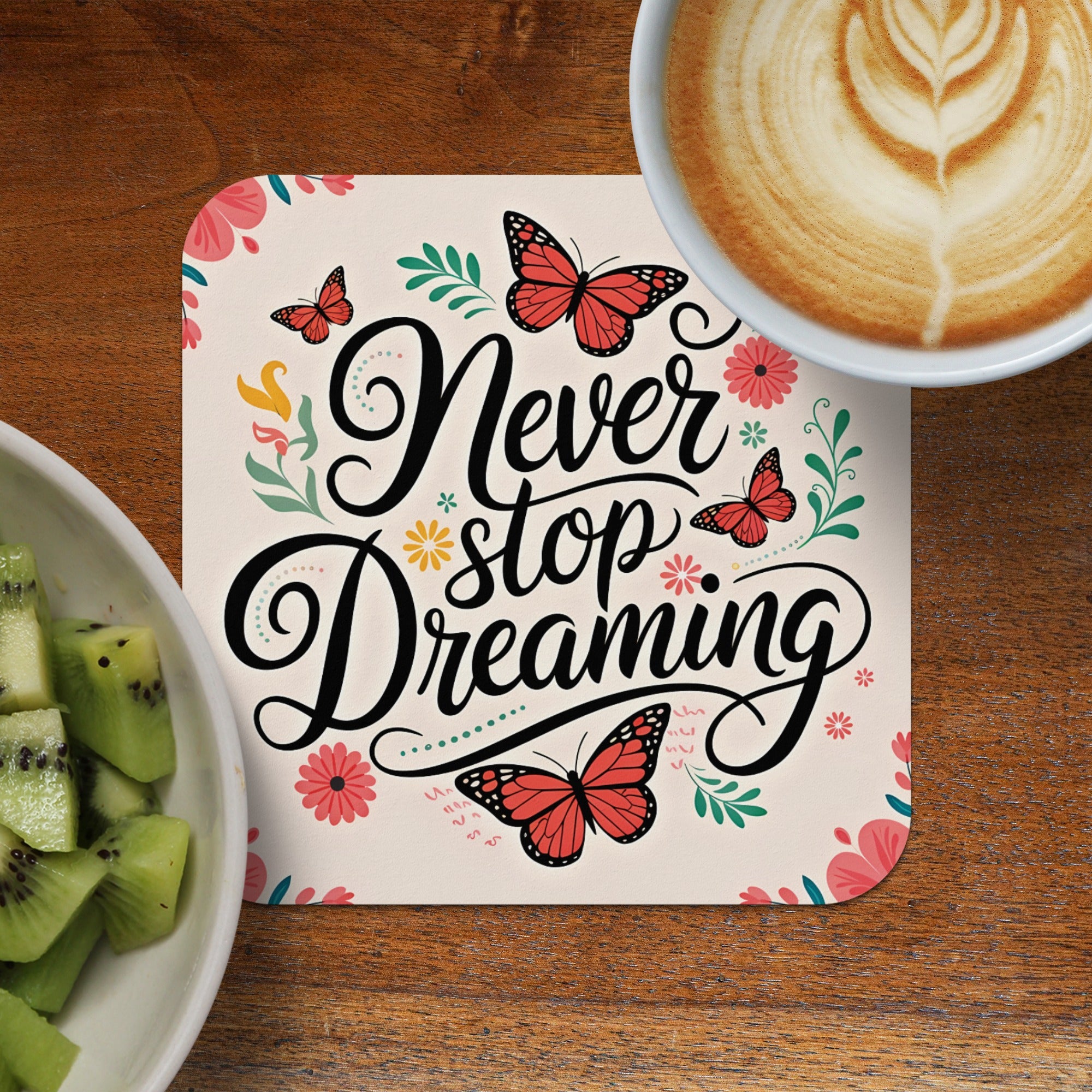 Never stop dreaming inspirational quote with butterflies and floral accents.