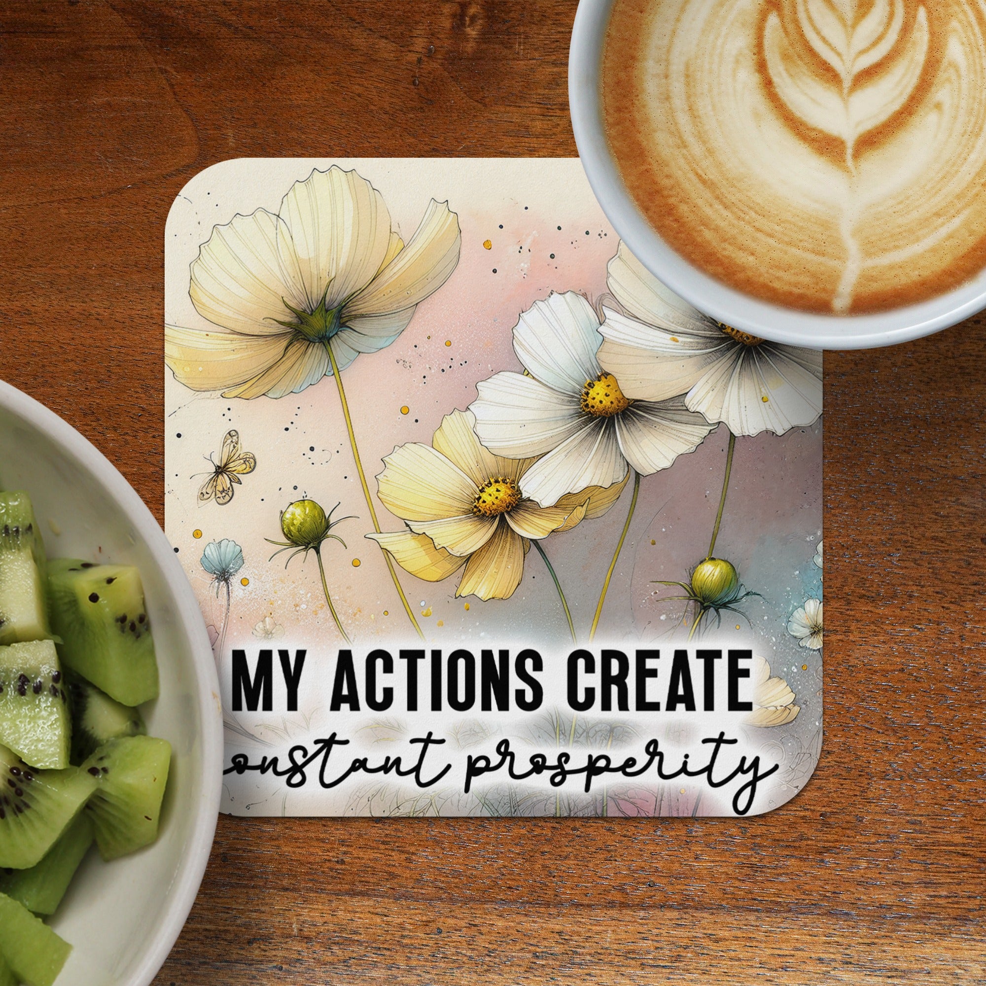 Coaster with yellow cosmos flowers and text "MY ACTIONS CREATE constant prosperity".